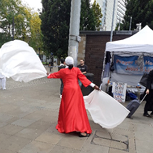 A photo of a lady dancing with flags